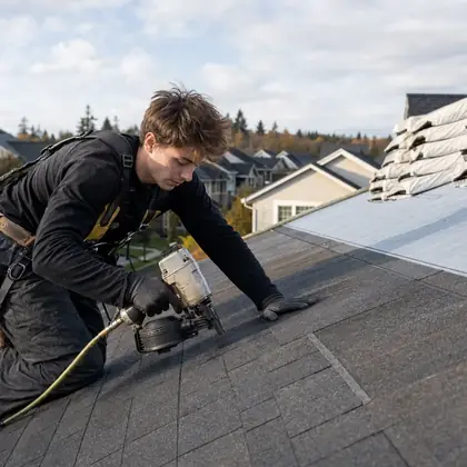 A roofer fitting shingles